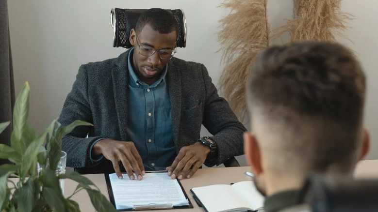 Hirer looking at a printout of a candidate CV