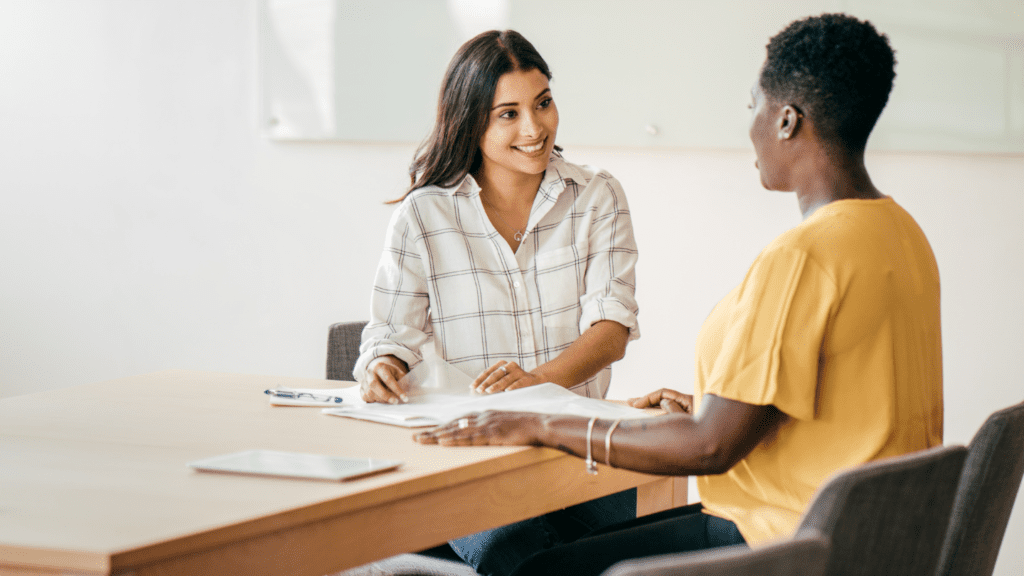 Director of HR conducting a stay interview with one of their employees to improve staff retention